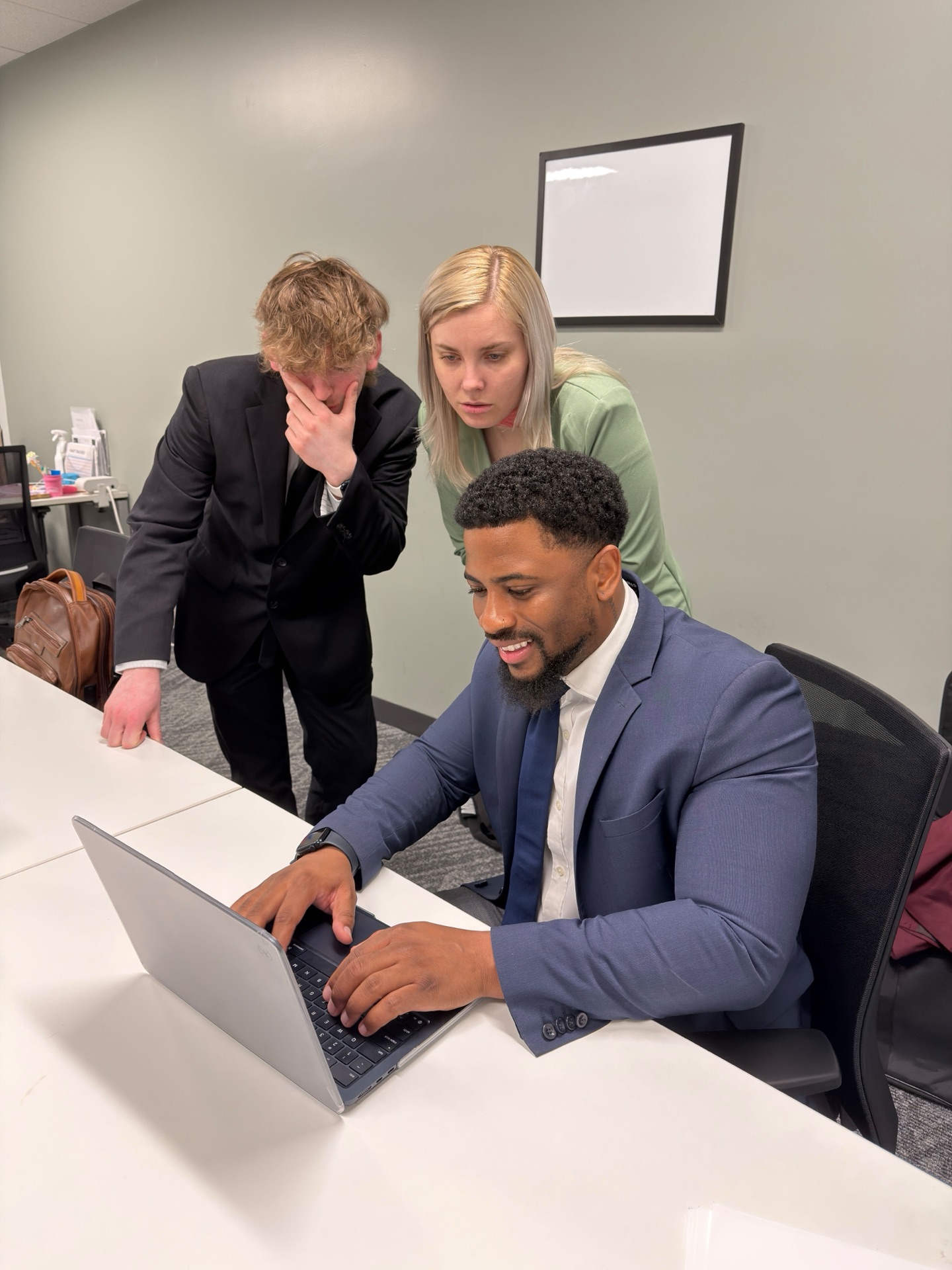 Essential Solutions Marketing team reviewing strategy together on a laptop